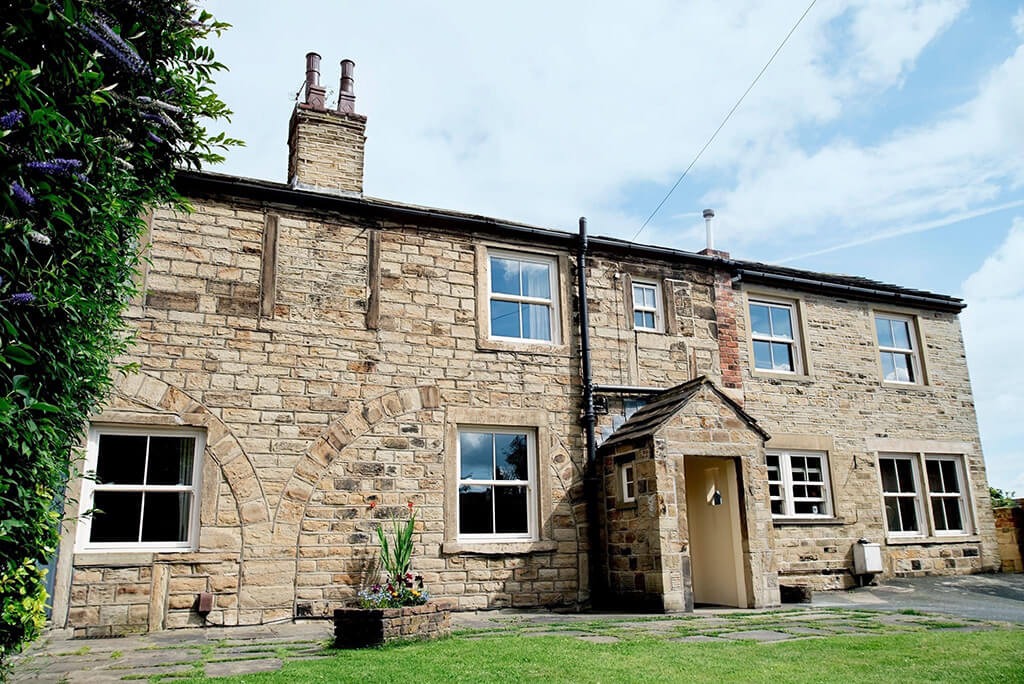 White Upvc sash windows on a traditional house exterior